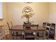 Charming dining area with table, four chairs, wicker mirror, and decorative chandelier at 1676 Northridge Dr, Morrow, GA 30260