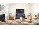 Bright living room with hardwood floors, blue media center, and comfortable neutral-toned furniture at 1676 Northridge Dr, Morrow, GA 30260