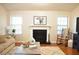 Inviting living room features a fireplace, a cozy couch, and hardwood floors at 1676 Northridge Dr, Morrow, GA 30260