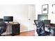 Well-lit office with desks, computers, and hardwood floors at 1676 Northridge Dr, Morrow, GA 30260
