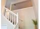 Staircase with white railing, neutral walls, and view toward a large houseplant at 1676 Northridge Dr, Morrow, GA 30260