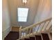 Carpeted staircase with a skylight, white railing, and a view to the front door at 1676 Northridge Dr, Morrow, GA 30260