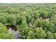 An aerial view captures wooded lot with a serene pond nearby at 1922 Knipe Sw Dr, Marietta, GA 30064