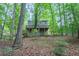 Wooded backyard view with the house's deck nestled among trees, offering a blend of nature and home at 1922 Knipe Sw Dr, Marietta, GA 30064