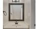 Well-lit bathroom features new vanity, updated fixtures, and a decorative dark framed mirror at 1922 Knipe Sw Dr, Marietta, GA 30064