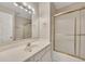 Bright bathroom with vanity sink and shower featuring a glass door, complemented by a well-lit mirror at 1922 Knipe Sw Dr, Marietta, GA 30064