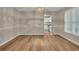 Well-lit dining room with wood floors, neutral walls, decorative molding, and a view into the kitchen at 1922 Knipe Sw Dr, Marietta, GA 30064
