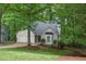 Well-maintained single-Gathering home with a two-car garage, complemented by a lush green lawn and mature trees at 1922 Knipe Sw Dr, Marietta, GA 30064