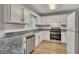 Updated kitchen boasts white cabinets, stainless steel appliances, and granite countertops at 1922 Knipe Sw Dr, Marietta, GA 30064