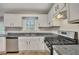 Well-lit kitchen features stainless appliances, ample counter space, and white cabinetry at 1922 Knipe Sw Dr, Marietta, GA 30064