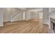 Bright living room with wood floors, a fireplace, staircase, and neutral paint, creating a cozy atmosphere at 1922 Knipe Sw Dr, Marietta, GA 30064