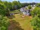 Aerial view showcases the home's large lot, mature trees, and backyard fire pit at 1314 Durham Ter, Mcdonough, GA 30252