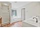 Neutral bathroom featuring a bathtub, shower and a large sink at 1314 Durham Ter, Mcdonough, GA 30252