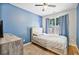 Serene bedroom features a window with natural light, complemented by blue walls and hardwood flooring at 1314 Durham Ter, Mcdonough, GA 30252