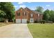 Charming two-story brick home with a well-manicured lawn, two-car garage and mature trees at 1314 Durham Ter, Mcdonough, GA 30252