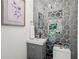 Quaint bathroom featuring gray vanity and a unique mirror tile wall at 1749 Ridge Valley Nw Ct, Atlanta, GA 30327
