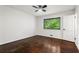 Clean bedroom features wood floors, a ceiling fan, and a window with leafy outdoor views at 1749 Ridge Valley Nw Ct, Atlanta, GA 30327