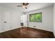 Bedroom featuring wood floors, neutral walls, a ceiling fan and a window with leafy outdoor views at 1749 Ridge Valley Nw Ct, Atlanta, GA 30327