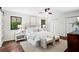 Bedroom with hardwood floors, two windows, ceiling fan, and two chairs at the foot of the bed at 1749 Ridge Valley Nw Ct, Atlanta, GA 30327