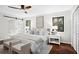 Well-lit bedroom with hardwood floors, a sliding door to the bathroom, and modern decor at 1749 Ridge Valley Nw Ct, Atlanta, GA 30327
