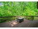 Wood deck offering a table, chairs, and a natural wooded views at 1749 Ridge Valley Nw Ct, Atlanta, GA 30327