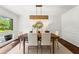 Elegant dining room with a modern chandelier, large window, and a stylish table setting at 1749 Ridge Valley Nw Ct, Atlanta, GA 30327