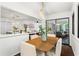 Open floorplan dining room with hardwood floors, view into living room, and sliding doors at 1749 Ridge Valley Nw Ct, Atlanta, GA 30327