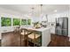 Spacious kitchen featuring a large island, white cabinets, modern appliances, and a breakfast nook at 1749 Ridge Valley Nw Ct, Atlanta, GA 30327