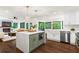 Open kitchen with a large island, white cabinets, modern appliances, and dark hardwood floors at 1749 Ridge Valley Nw Ct, Atlanta, GA 30327