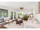 Open floorplan living room with hardwood floors and view into adjacent kitchen at 1749 Ridge Valley Nw Ct, Atlanta, GA 30327