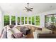 Sunroom featuring a vaulted ceiling, wood floors, multiple windows, and wicker furniture at 1749 Ridge Valley Nw Ct, Atlanta, GA 30327