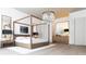Bright bedroom with a four-poster bed, stylish nightstands, and a chic chandelier for a cozy atmosphere at 260 Mayfield Rd, Alpharetta, GA 30009