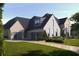 Beautiful two-story home with a three-car garage and well-manicured lawn at 260 Mayfield Rd, Alpharetta, GA 30009