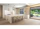 Beautiful kitchen with double islands, marble countertops and connection to outdoor pool area at 260 Mayfield Rd, Alpharetta, GA 30009