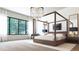 Serene main bedroom with four poster bed, designer lighting, and a calming view of nature at 260 Mayfield Rd, Alpharetta, GA 30009
