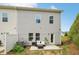Exterior of home with a small patio featuring seating and a grill in the backyard at 302 Braswell Ct, Woodstock, GA 30188