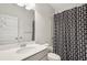 Neutral bathroom featuring a single sink vanity with a modern geometric pattern shower curtain at 302 Braswell Ct, Woodstock, GA 30188