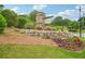 Stone signage surrounded by manicured landscaping at the community entrance, creating a welcoming and upscale feel at 302 Braswell Ct, Woodstock, GA 30188
