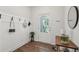 Stylish entryway with hardwood floors, coat rack, and modern decor accents at 302 Braswell Ct, Woodstock, GA 30188