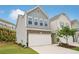 Charming two-story townhome with a two-car garage and professionally landscaped front yard at 302 Braswell Ct, Woodstock, GA 30188