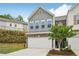 Charming two-story townhome with a two-car garage and professionally landscaped front yard at 302 Braswell Ct, Woodstock, GA 30188