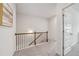 Upstairs hallway with a decorative painting, door, and railing at 302 Braswell Ct, Woodstock, GA 30188