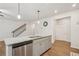 Open kitchen featuring stainless steel appliances, granite countertops, and seamless flow to staircase at 302 Braswell Ct, Woodstock, GA 30188