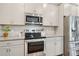 The well-equipped kitchen offers stainless steel appliances, granite countertops, and ample cabinet space at 302 Braswell Ct, Woodstock, GA 30188