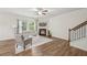 Spacious living room with hardwood floors, a cozy fireplace, and staircase access at 302 Braswell Ct, Woodstock, GA 30188