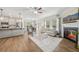 Open-concept living area featuring a modern kitchen, dining area, and cozy fireplace at 302 Braswell Ct, Woodstock, GA 30188
