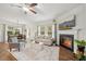 Open-concept living room featuring a fireplace, hardwood floors, and modern furnishings at 302 Braswell Ct, Woodstock, GA 30188