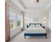 Bright, spacious main bedroom featuring tray ceilings, paneling, and stylish lighting at 302 Braswell Ct, Woodstock, GA 30188