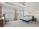 Bright, spacious main bedroom featuring tray ceilings, paneling, and stylish lighting at 302 Braswell Ct, Woodstock, GA 30188