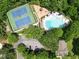 Aerial view of the community pool, tennis courts, and playground, surrounded by mature trees and greenery at 3052 Fleet Sw St, Marietta, GA 30064
